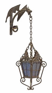 SPANISH GAUDI STYLE WROUGHT IRON WALL LANTERN: Wrought iron wall-hanging lantern, in the manner of Antoni Gaudi (Spanish, 1852-1926), early 20th c., wall bracket with stylized figural dragon, chain suspension issuing lantern with scrolled frame, i