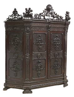 MONUMENTAL ITALIAN RENAISSANCE REVIVAL ARMOIRE: Monumental Italian Renaissance Revival armoire, 19th c., the whole heavily carved in scrolling foliates, having pierced figural carved crests, over canted case, fitted with four doors, rising on lion