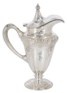 BARBOUR STERLING 'LOUIS NOUVEAU' SILVER PITCHER: American sterling silver footed syrup pitcher, Barbour Silver Company, in the "Louis Nouveau" pattern, top finial to lid, in a repousse and chased scrolled design, gilt wash to interior, monogram at o