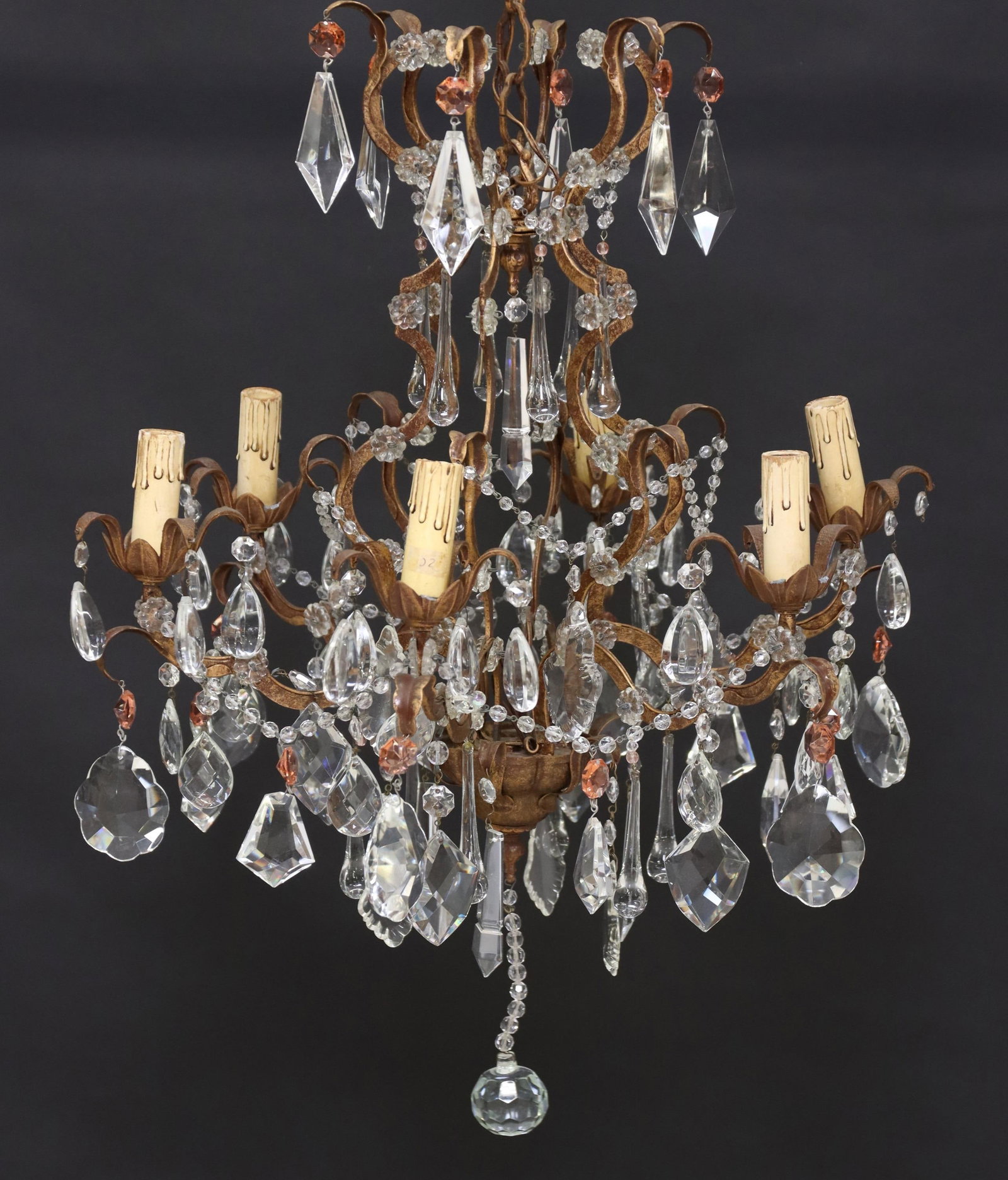 CONTINENTAL SCROLLED CRYSTAL 6-LT CHANDELIER: Continental metal and crystal six-light chandelier, early 20th c., having scrolled frame, issuing six scalloped arms, ending on floral bobeches and faux candles, hung with faceted crystal pendalogues,