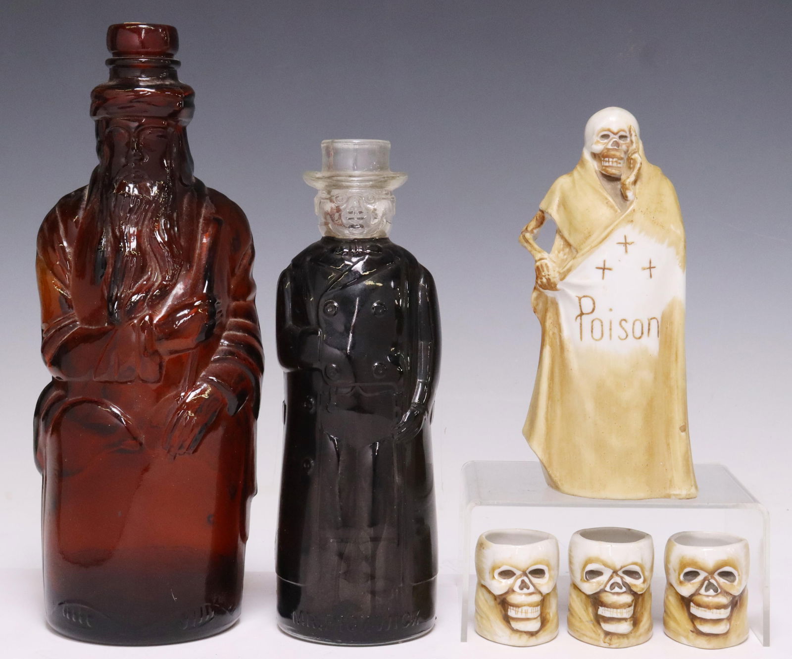 (6) JAPAN GRIM REAPER DECANTER SET & GLASS BOTTLES: (lot of 6) Bottles, including: (1) Hiram Ricker & Sons, Inc. molded amber glass bottle, facsimile of first Poland "Moses" water bottle, approx 10.75"h, (1) Mr. Pickwick vinegar bottle, approx 8.75"h,