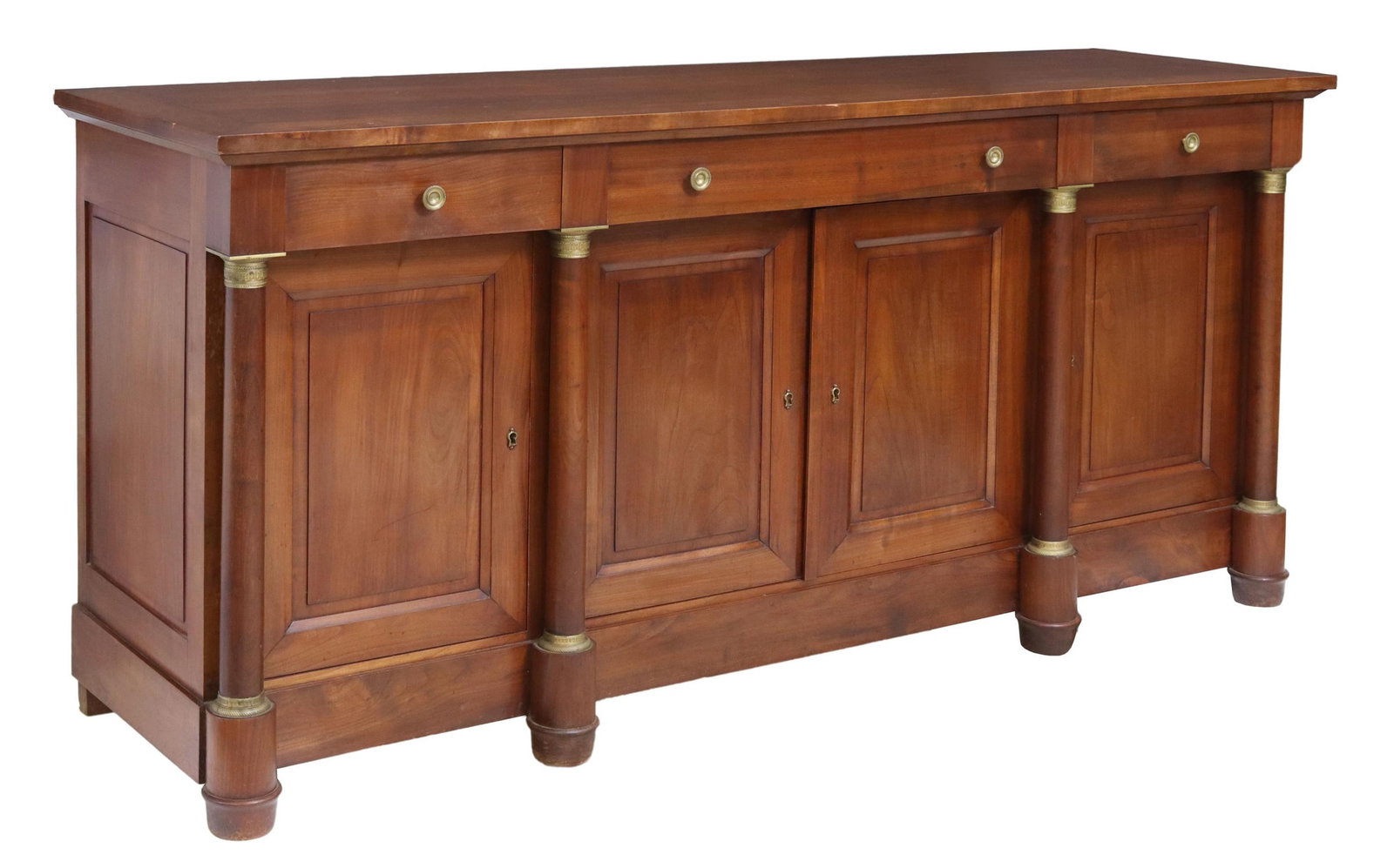 FRENCH EMPIRE STYLE WALNUT SIDEBOARD: French Empire style walnut sideboard, 20th c., having rectangular top, over three drawers and four cabinet doors, interior shelves, gilt metal accents, framed by turned columns, approx 37.25"h, 77.75"