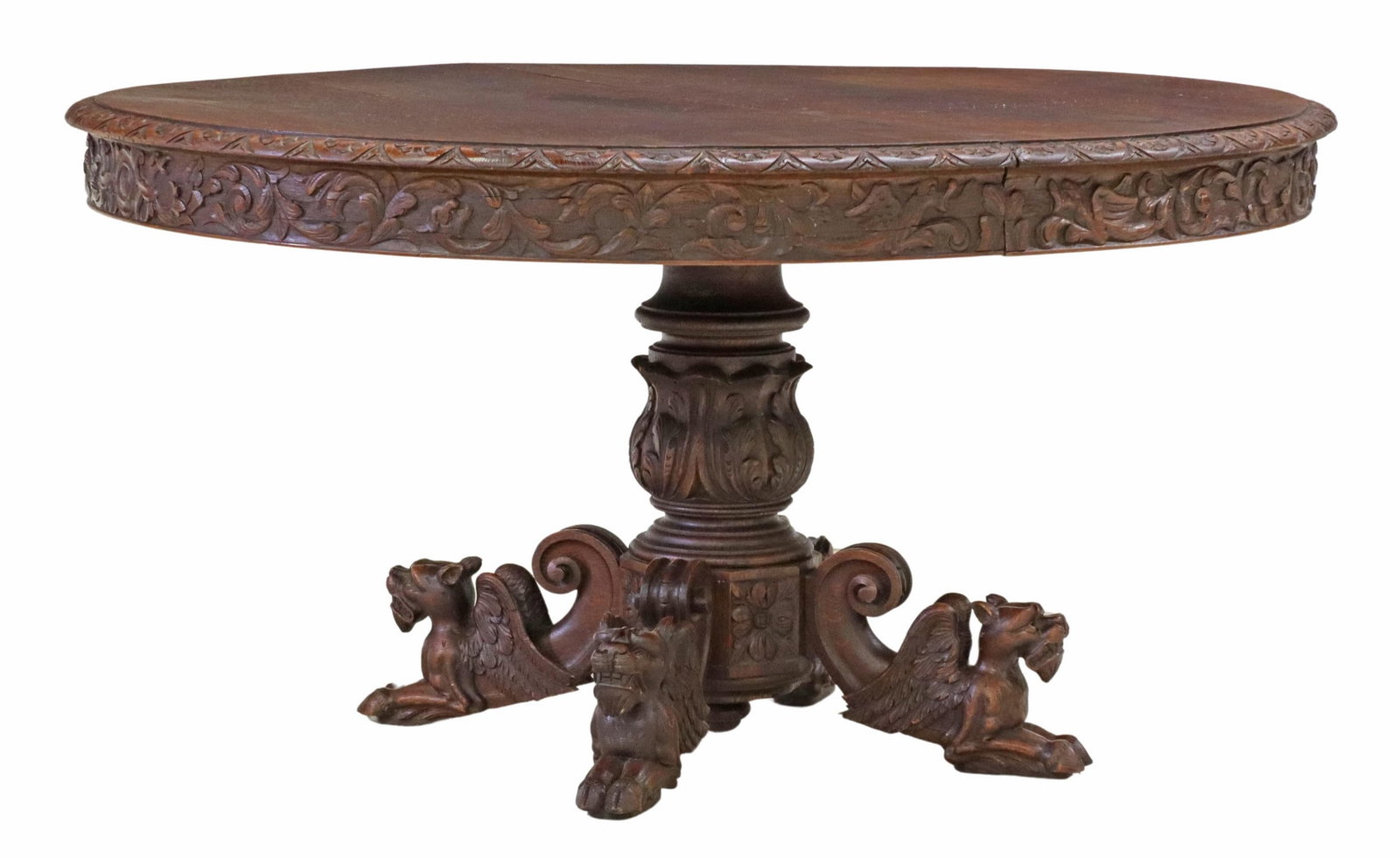 FRENCH RENAISSANCE REVIVAL OAK EXTENSION TABLE: French Renaissance Revival carved oak extension table, late 19th c., having oval top with molded apron, central turned pedestal, flanked by figural supports modeled as winged grotesques, accompanied b
