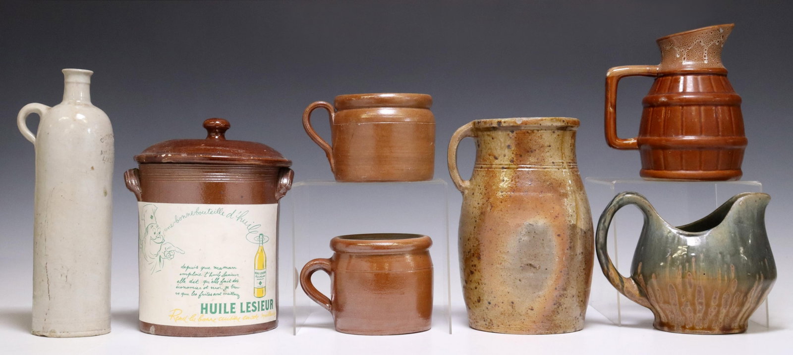 (7) FRENCH STONEWARE POTTERY VESSELS: (lot of 7) French stoneware pottery vessels, including Huile Lesieur jar and cover, curacao bottle, pitchers, etc., largest: approx 10"h, 7.5"diam; 17lbs total Start Price: $50.00