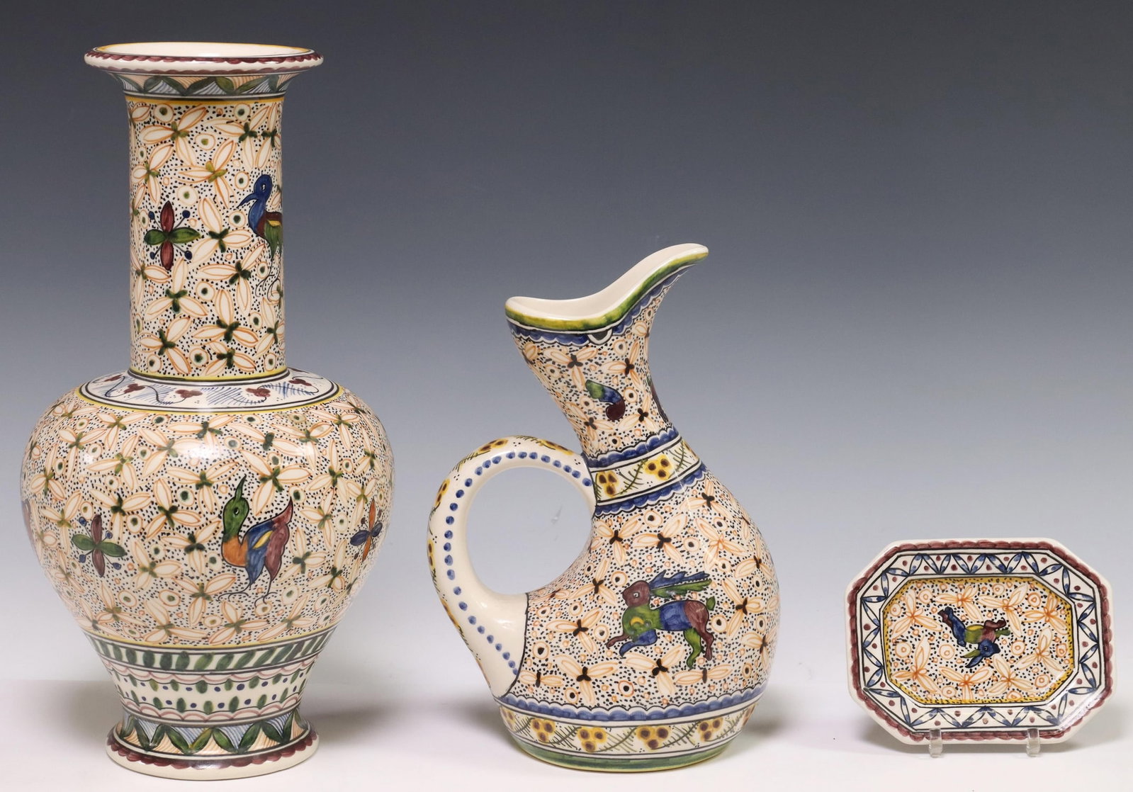 (3) ESTRELA DE CONIMBRIGA PORTUGUESE POTTERY WARES: (lot of 3) Glazed pottery tableware, Estrela de Conimbriga, Portugal, 20th c., each with painted animals, floral medallions, and geometric motifs, maker's mark underfoot, including: (1) vase, approx 1
