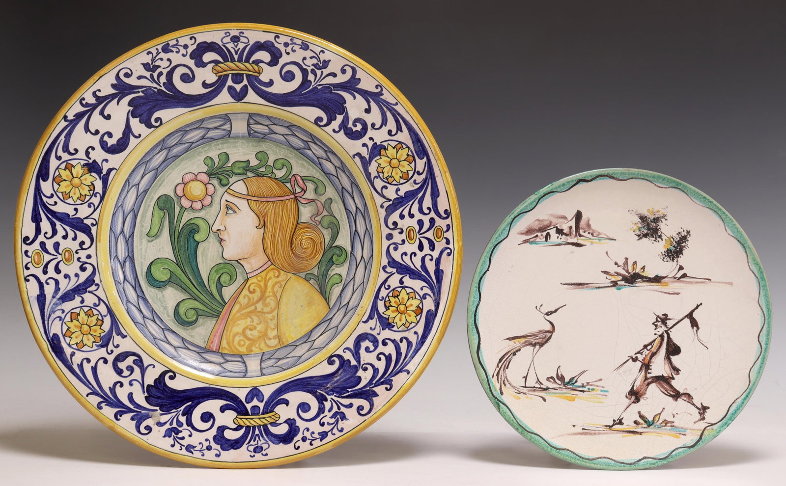 (2) ITALIAN MAJOLICA CHARGER & PLATE, ITALICA ARS: (lot of 2) Italian majolica dishes, 20th c., including: (1) charger, Italica Ars, with central portrait, flanked by floral medallions and scrolled foliates, approx 15"diam; (1) plate, having painted f