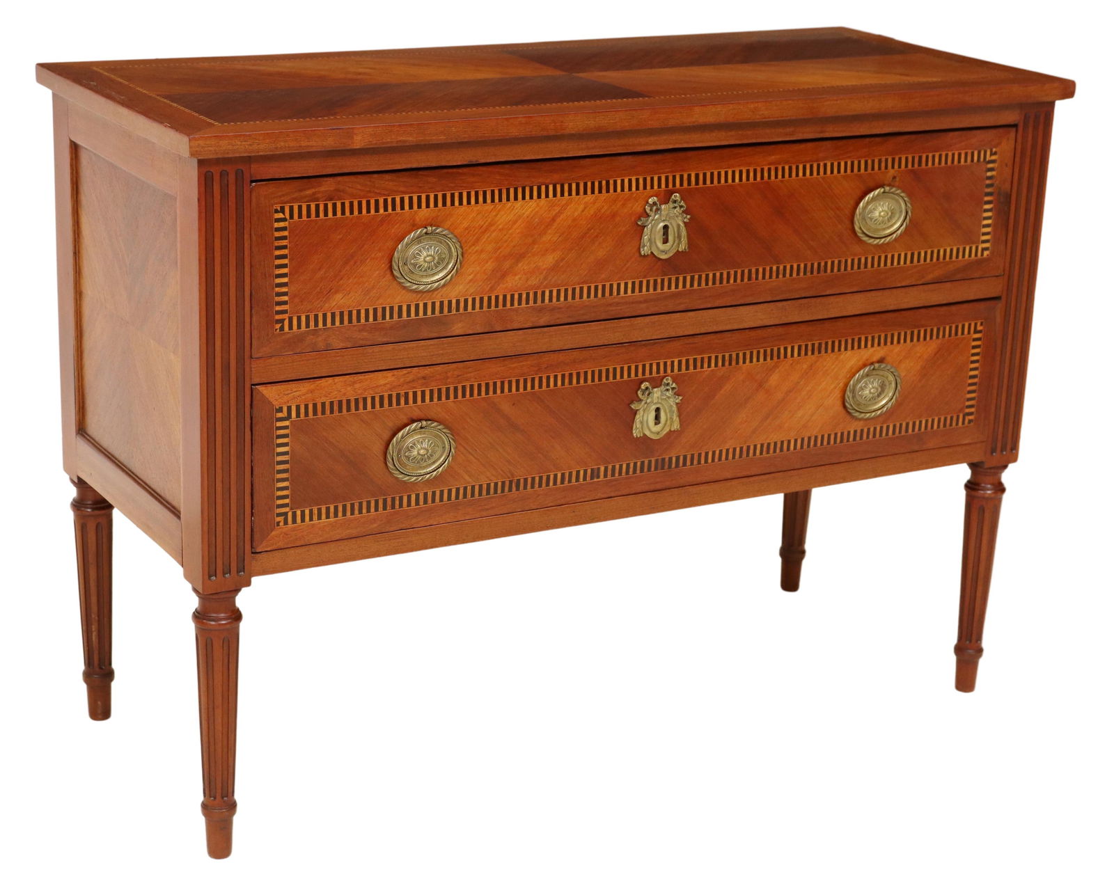 FRENCH LOUIS XVI STYLE INLAID MAHOGANY COMMODE: French Louis XVI style inlaid mahogany commode, early 20th c., having rectangular top, over two drawers, with banded parquetry designs, fluted corner posts, rising on fluted tapered legs, ending on ar