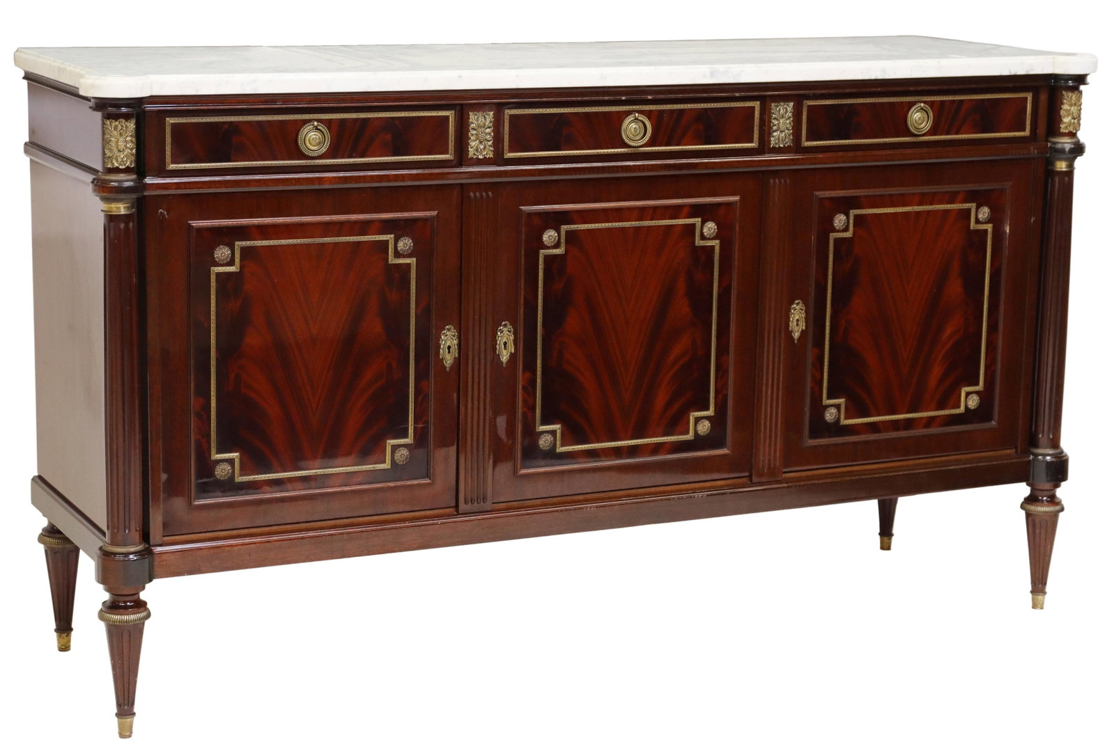 LOUIS XVI STYLE MARBLE-TOP MAHOGANY SIDEBOARD: French Louis XVI style marble-top sideboard, late 20th c., mahogany case with gilt metal trim, three felt-lined drawers, over three cabinet doors, opening to interior shelf, on tapering fluted legs, a