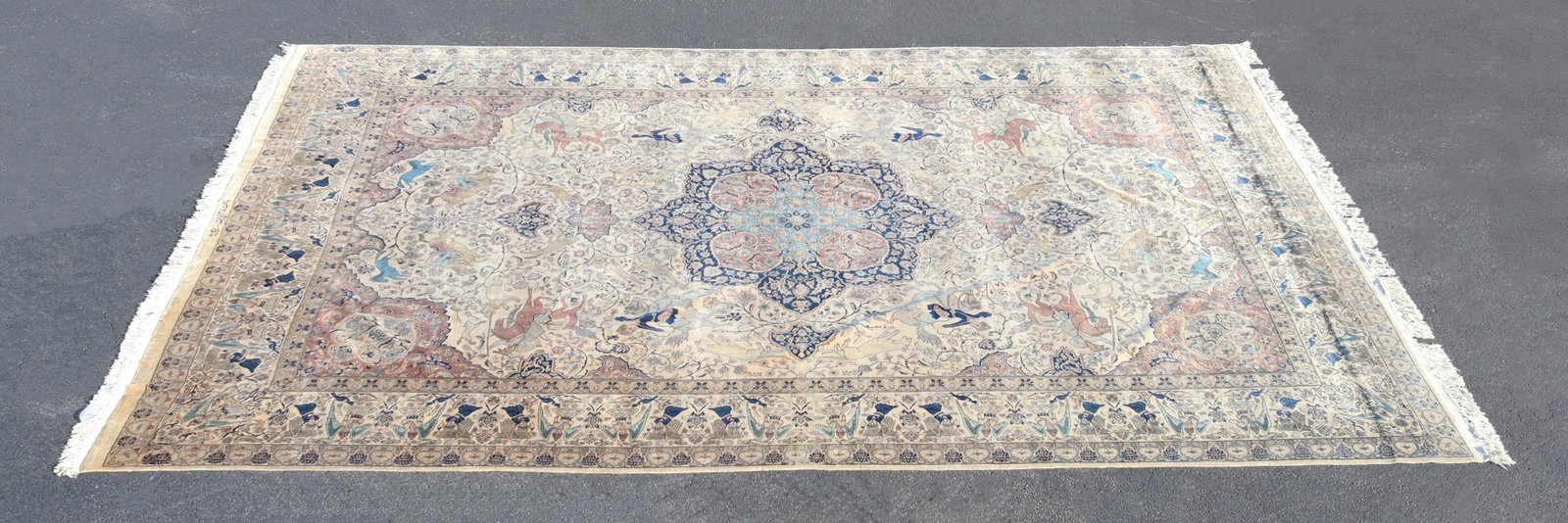 SIGNED HAND-TIED AGRA RUG, INDIA, 18'1" X 13'2": Hand-woven Agra rug, India, central medallion hunting scene in blues and soft mauve on ivory background with ivory border featuring angel motif, signed "woven by Gholam Mohyaldin 1373 (1953)," approx 