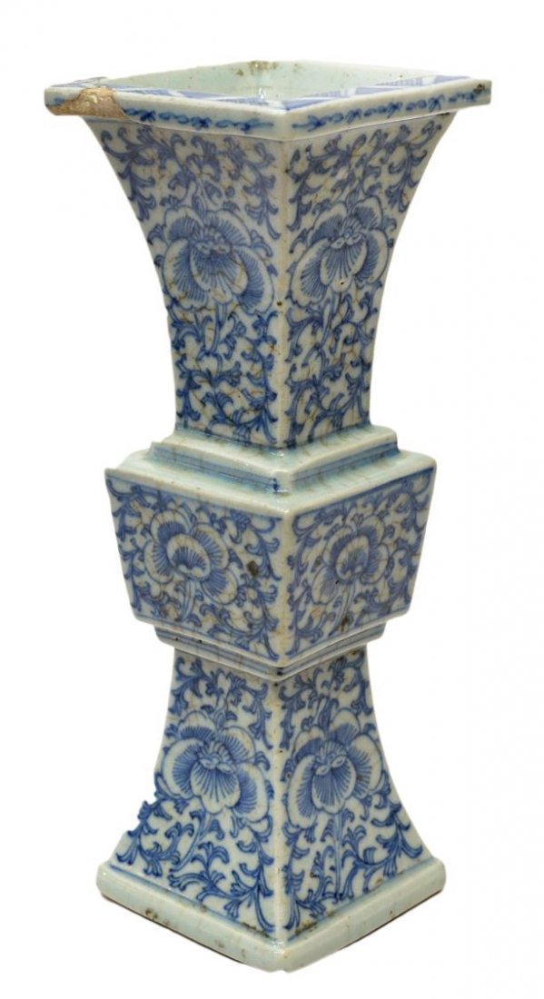 CHINESE QING DYNASTY BLUE & WHITE PORCELAIN VASE: Chinese blue and white porcelain vase, Qing Dynasty, of squared gu form with flared neck and foot, decorated with flowers amid a ground of scrolling leafy tendrils, restoration, loss at rim, crazing o