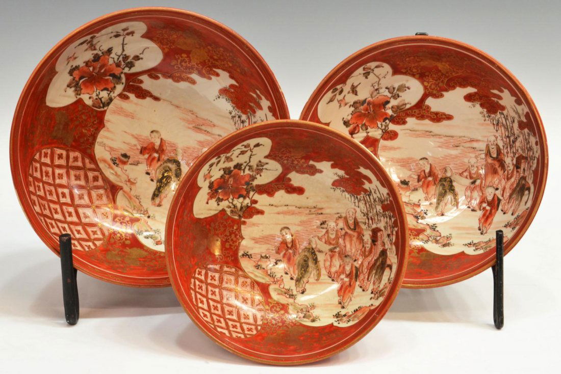 (3)JAPANESE KUTANI EARTHENWARE BOWLS, MEIJI PERIOD: (lot of 3) Japanese Kutani earthenware bowls, Meiji period, of graduated size and decorated in the kinrande palette with figural, floral and geometric panels reserved on a gilt and red enamel ground o