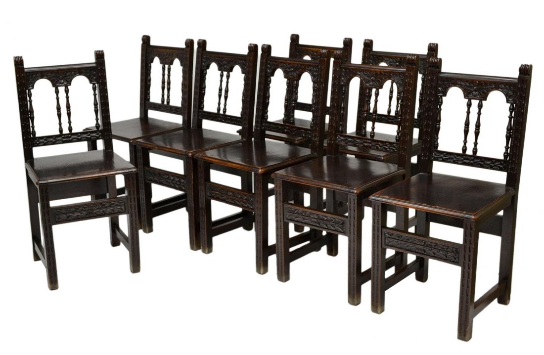 (8) ANTIQUE SPANISH CARVED LIBRARY CHAIRS: (lot of 8) Spanish chairs, Barcelona c. 1900, each having foliate carved crest rails with scrolled ends over the open center with four spindles, solid wood seat, squared legs with foliate carved stret