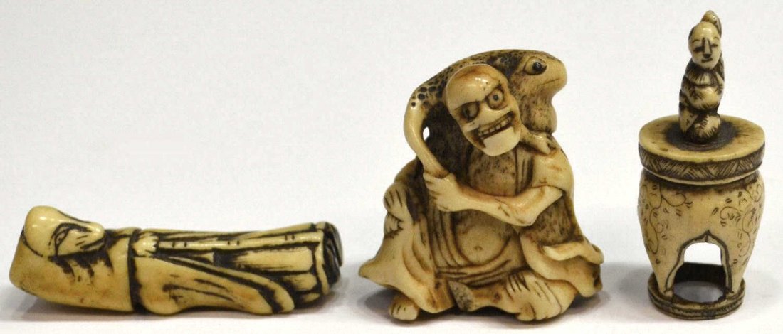 (3) JAPANESE STAG ANTLER NETSUKE, EDO/MEIJI: (lot of 3) Japanese stag antler figural netsuke, Edo/Meiji period, 19th century, each with dark pigment accents: (1) Chinese immortal, probably Gama Sennin, seated in a hermit's cape and apron of mugw