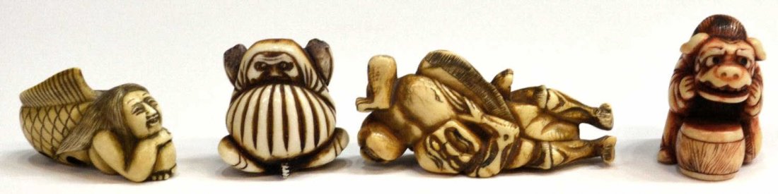 (4) JAPANESE TINTED IVORY/STAG ANTLER NETSUKE: **This lot will not be shipped Internationally**(lot of 4) Japanese tinted ivory or stag antler figural toggles: (1) red-tinted stag antler netsuke of a kneeling lion dancer, inlaid eyes (wear to stai