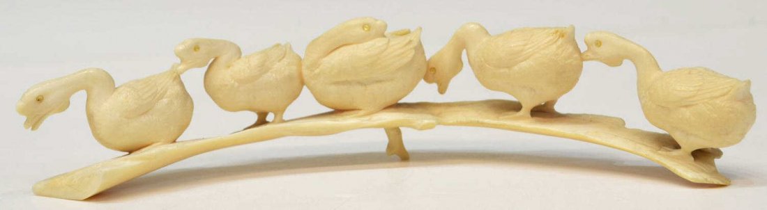 JAPANESE IVORY CARVING OF GEESE: **This lot will not be shipped Internationally** Japanese ivory tusk carving, five geese having applied eyes, standing upon the arched tusk carved as a trunk, raised on twig form stand, 8"l, .25lb **P