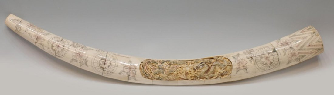 CHINESE INCISED PANELED BONE TUSK FORM SCULPTURE: Large Chinese sculpture in the form of a tusk, applied bone panels incised and pigmented with flowering foliates, center detail of a dragon and phoenix, 36.5"l, 3.75"diam (widest), 6lbs total