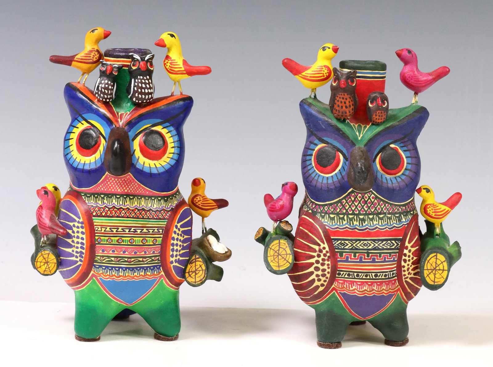 ALFONSO CASTILLO ORTA (MX, D2009) FOLK ART POTTERY: (lot of 2) Polychrome painted folk art pottery single-light owl candelabras, each initialed AMC verso (Alfonso Castillo Orta, Izucar de Matamoros, Puebla, Mexico, 1944-2009), varied designs, with appl