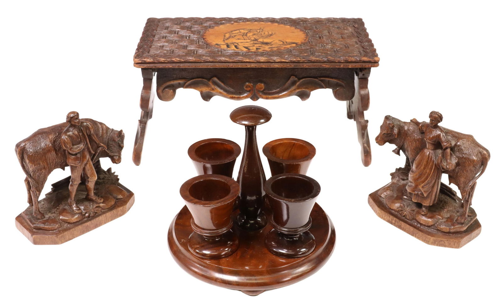 (4) BLACK FOREST CARVINGS & TREEN EGG CUPS: (lot of 4) Carved wood table articles, including: (1) Black Forest collapsible stand, top with carved basket weave pattern, penwork cartouche with chamois/ mountain goats, approx 6"h, 11.25"w, 5.75"d,