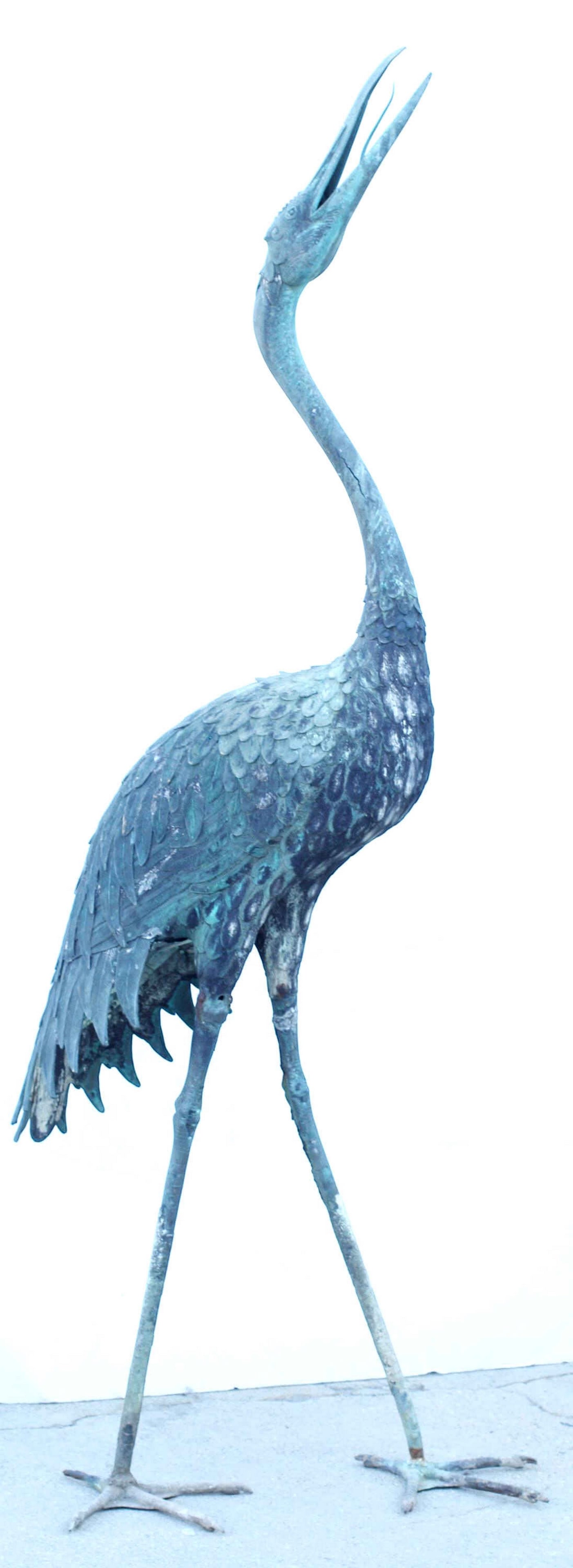 LARGE PATINATED METAL SCULPTURE OF A CRANE, 73.5"H: Verdigris patinated metal sculpture of a crane or heron, standing sturdy and intact with restorations and some splits to metal, approx 73.5"h, 28"w, 25"d **PLEASE NOTE: All of the cast stone and garde