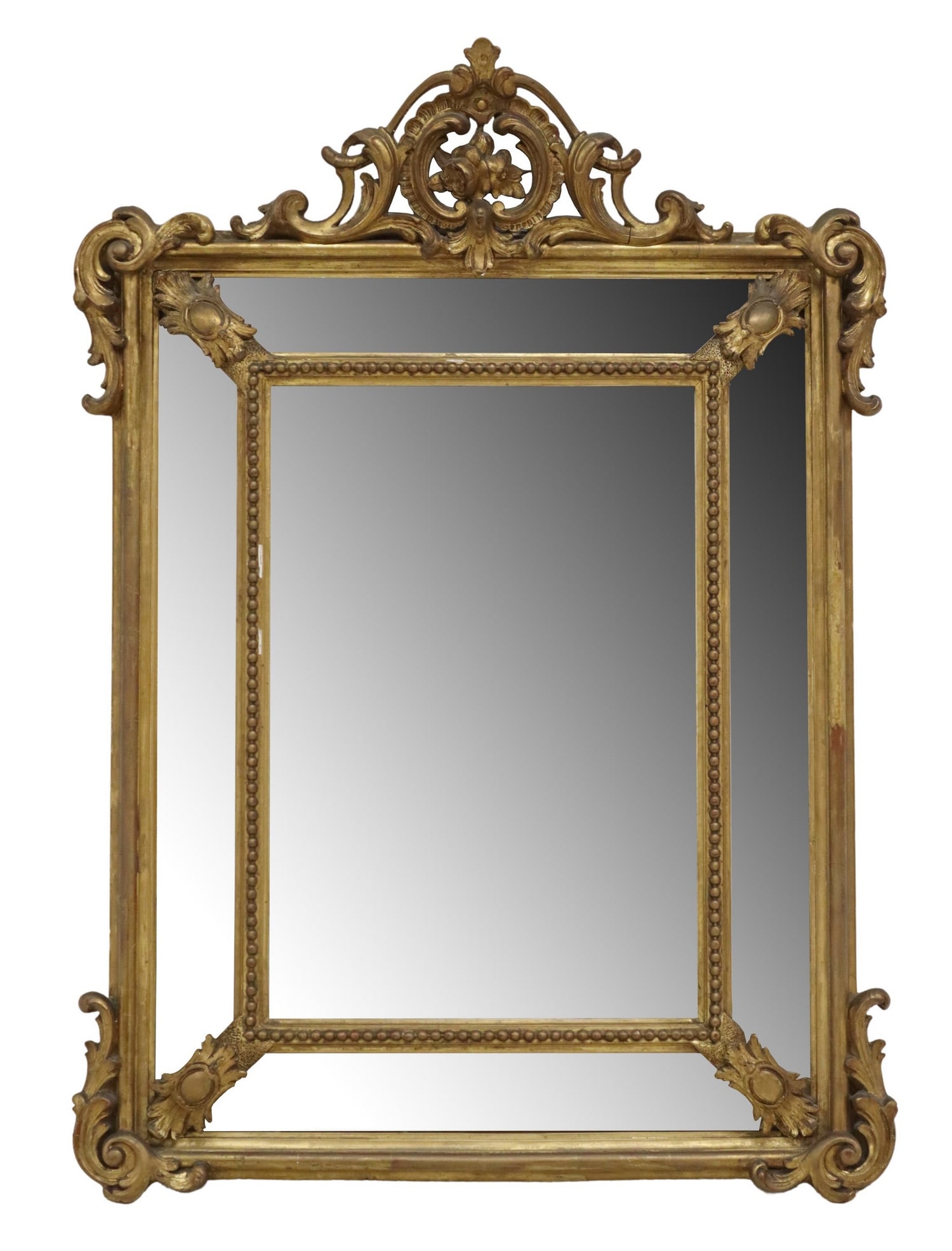 FRENCH LOUIS XV STYLE GILTWOOD CUSHION MIRROR: French Louis XV style giltwood wall mirror, early 20th c., having pierced foliate crest with central floral medallion, over cushion frame with beaded trim, encasing beveled mirror plate, some minor si
