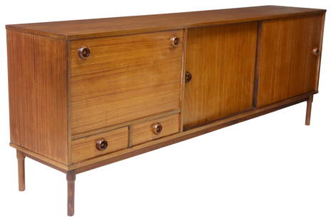ITALIAN MID-CENTURY MODERN ROSEWOOD SIDEBOARD: Italian mid-century modern rosewood sideboard, c.1960s, fall-front cabinet over two drawers, flanked by dual sliding doors, on cylindrical legs, hinges marked "Trola made in Germany," approx 31.75"h,