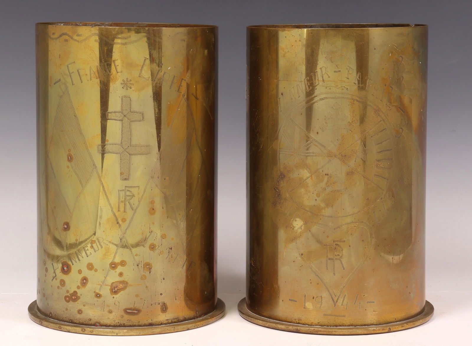 2)FRENCH WWII-ERA TRENCH ART ARTILLERY SHELL VASES: (lot of 2) Large French WWII-era trench art vases, fashioned from artillery shells, each inscribed "France Libre Honneur Patrie 1944," with incised cross and heart motifs, approx 10.25"h, 7"diam, 19.2