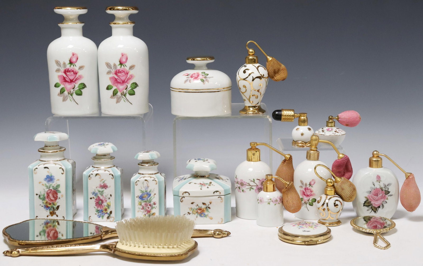 19)PORCELAIN & GILT METAL PERFUMES & DRESSER ITEMS: (lot of 19) Porcelain and gilt metal perfume bottles & dresser items, highlights include: (3) French lidded jars, each with transfer roses, marked Veritable Porcelaine underfoot, (4) lidded containers