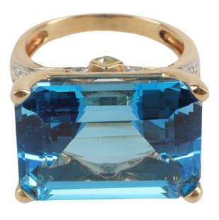 ESTATE 14KT GOLD LONDON BLUE TOPAZ COCKTAIL RING: Estate 14kt yellow gold cocktail ring, emerald-cut London blue topaz, approx 30ct, prongs and shoulders accented with clear stones, likely clear quartz, hallmarked 14K, approx size 8.5, 10 grams