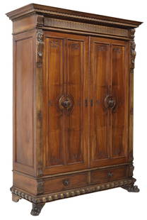 ITALIAN RENAISSANCE REVIVAL CARVED WALNUT ARMOIRE: Italian Renaissance Revival carved walnut armoire, early 20th c., molded cornice, two paneled doors opening to hanging rod, two exterior drawers below, on front paw feet, approx 88.5"h, 67"w, 26"d Sta