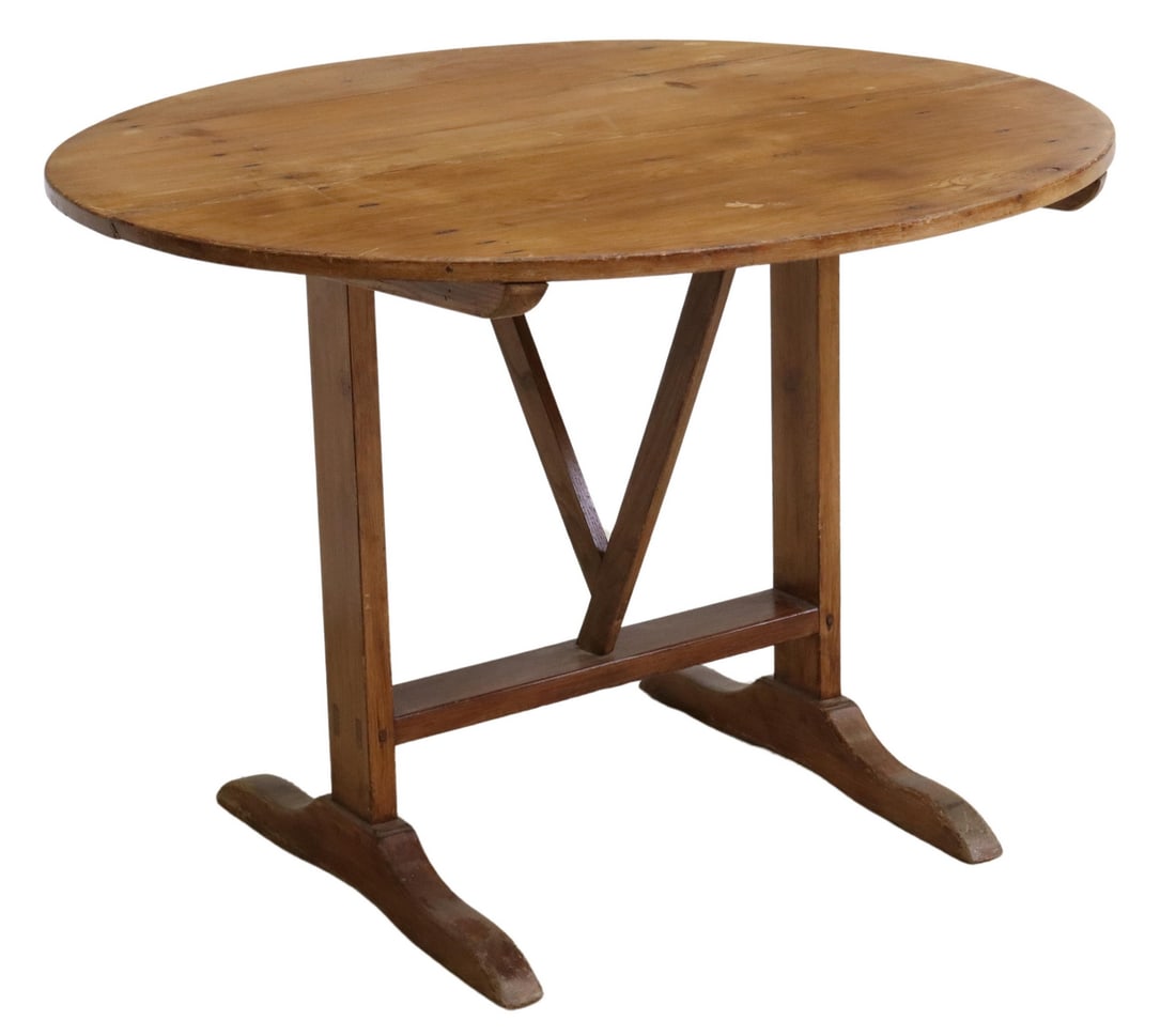 FRENCH PROVINCIAL PINE TILT-TOP WINE TASTING TABLE: French Provincial pine tilt-top wine tasting table, early 20th c., oval tabletop, on trestle base with swing harp-form support, approx 28.5"h, 39.5"w, 39.25"d, top up: approx 47.5"h Start Price: $300.