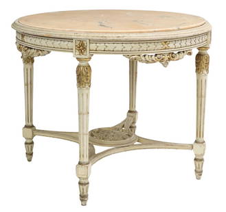 LOUIS XVI STYLE MARBLE-TOP PAINTED CENTER TABLE: Louis XVI style center table, 20th c., inset marble top, parcel gilt and painted frame, carved scrolled apron, rising on fluted legs, joined by shaped stretcher with central floral medallion, approx 3