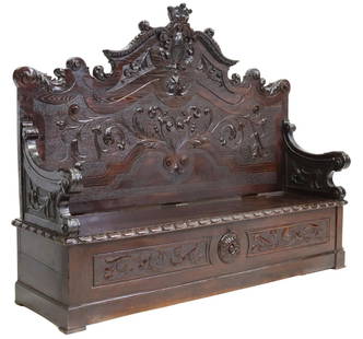 RENAISSANCE REVIVAL OAK COFFER-BASE HALL BENCH: Renaissance Revival oak hall bench, 19th c., shaped back with carved cartouche shield crest, framed by foliate scrolls, hinged bench seat opening to storage, approx 63.5"h, 79.75"w, 24"d Start Price: