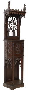 FRENCH GOTHIC REVIVAL CARVED OAK CREDENCE CUPBOARD: French Gothic Revival oak credence cupboard, late 19th c., pierced tracery panel supporting a canopy, single cabinet door framed by saint figures, interior shelf, on a bracket base, approx 90.25"h, 22