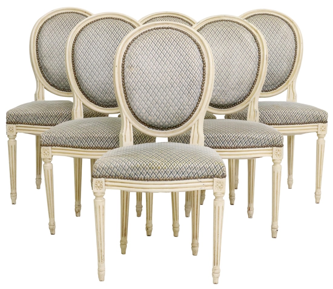 (6) FRENCH LOUIS XVI STYLE PAINTED CHAIRS: (lot of 6) French Louis XVI style upholstered side chairs, 20th c., having oval backs and cream painted frame, nail head trim, rising on fluted legs, approx 36.25"h, 19"w, 18.75"d, seat: 19"h Start Pr