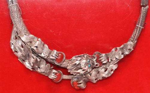 CHINESE STERLING SILVER DRAGON NECKLACE IN FRAME: Chinese sterling silver collar necklace, hinged frame with textural scales, centering figural dragon with inset red coral cabochons and blue beads, marked 925 at side, hinge broken at right side, now