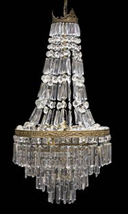 ITALIAN EMPIRE STYLE CRYSTAL CHANDELIER: Italian Empire style gilt metal and crystal chandelier, 20th c., crown hung with prism and hexagonal crystal swags, over three lights and three concentric graduated tiers, in need of wiring, approx 42