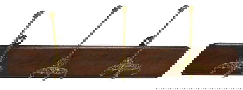 ITALIAN BRASS & WALNUT WALL-MOUNTED HAT/ COAT RACK: Italian wall-mounted hat/ coat rack, 20th c., having walnut backplate, issuing three scrolled brass hat/ coat hooks, approx 10"h, 33"w, 6.5"d Start Price: $50.00