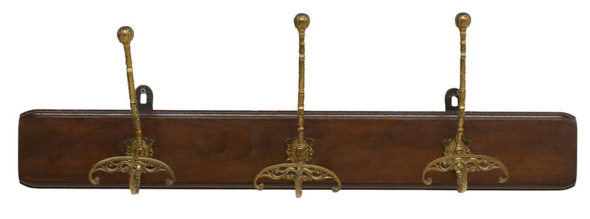 ITALIAN BRASS & WALNUT WALL-MOUNTED HAT/ COAT RACK: Italian wall-mounted hat/ coat rack, 20th c., having walnut backplate, issuing three scrolled brass hat/ coat hooks, approx 10"h, 33"w, 6.5"d Start Price: $50.00