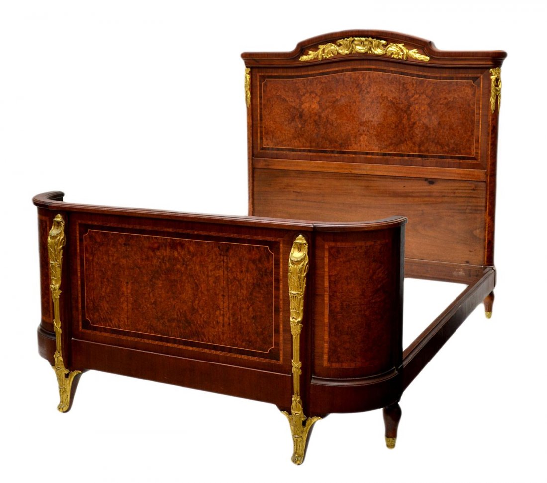 FRENCH LOUIS XVI STYLE BURLWOOD BED: French Louis XVI style burl wood mahogany bed with gilt ormolu decoration, early 1900's, the headboard with arched crest rail over ormolu, a curved footboard, headboard: 61"h, 60.5"w, footboard: 31.5"