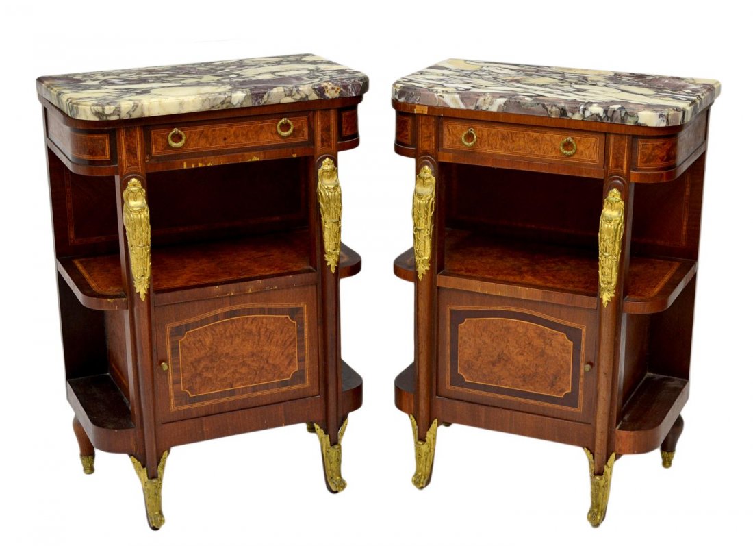 (2) FRENCH LOUIS XVI STYLE MARBLE TOP NIGHTSTANDS: (lot of 2) French Louis XVI style burl wood accented mahogany night stands with gilt ormolu decoration, early 1900's, each with marble top over a frieze drawer, an open shelf over the lower single doo