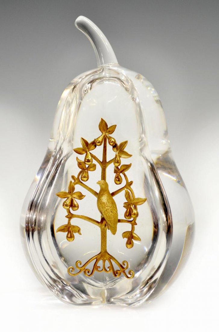 STEUBEN CRYSTAL & 18KT GOLD PARTRIDGE IN PEAR TREE: A Steuben Glass 'Partridge in a Pear Tree', designed by Lloyd Atkins, the colorless crystal fruit mounted with a gold partridge in a pear tree, root marked 18 K S, Steuben mark underfoot, some surface