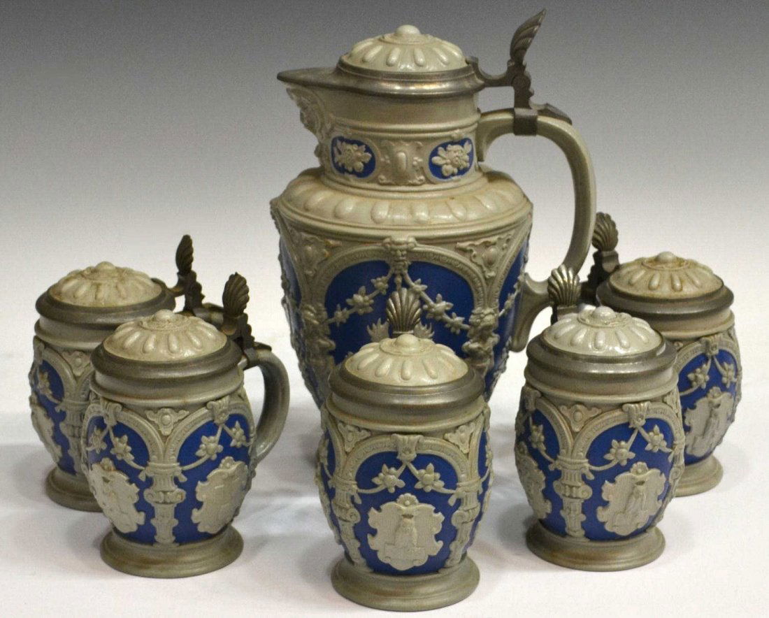 (6) VILLEROY & BOCH METTLACH POTTERY STEIN SERVICE: (lot of 6) German pottery stein service, Villeroy & Boch, Mettlach, c. 1874- 1909, relief decoration showing owl crests and foliage between columned reserves, shell form pewter thumb lift, comprising: