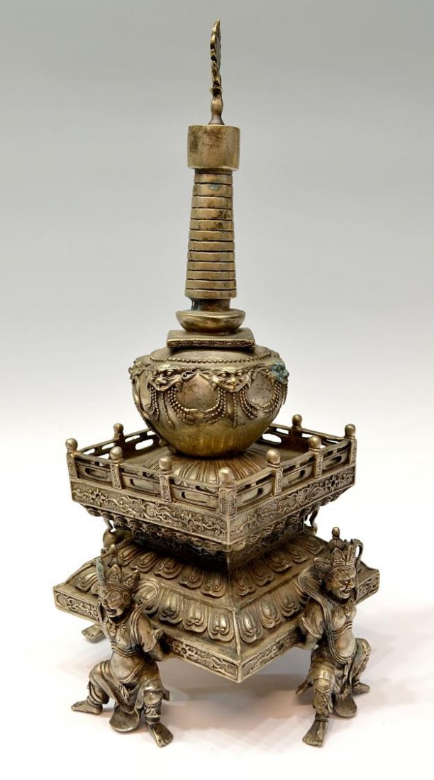BUDDHIST STUPA SHRINE, NEPAL / TIBET: Buddhist silver gilt metal consecrated stupa, Nepal / Tibet, mid 20th c., a removable symbolic reliquary top over the two tier step form shrine raised and supported by four Buddhist deities, 14.5"h, 7