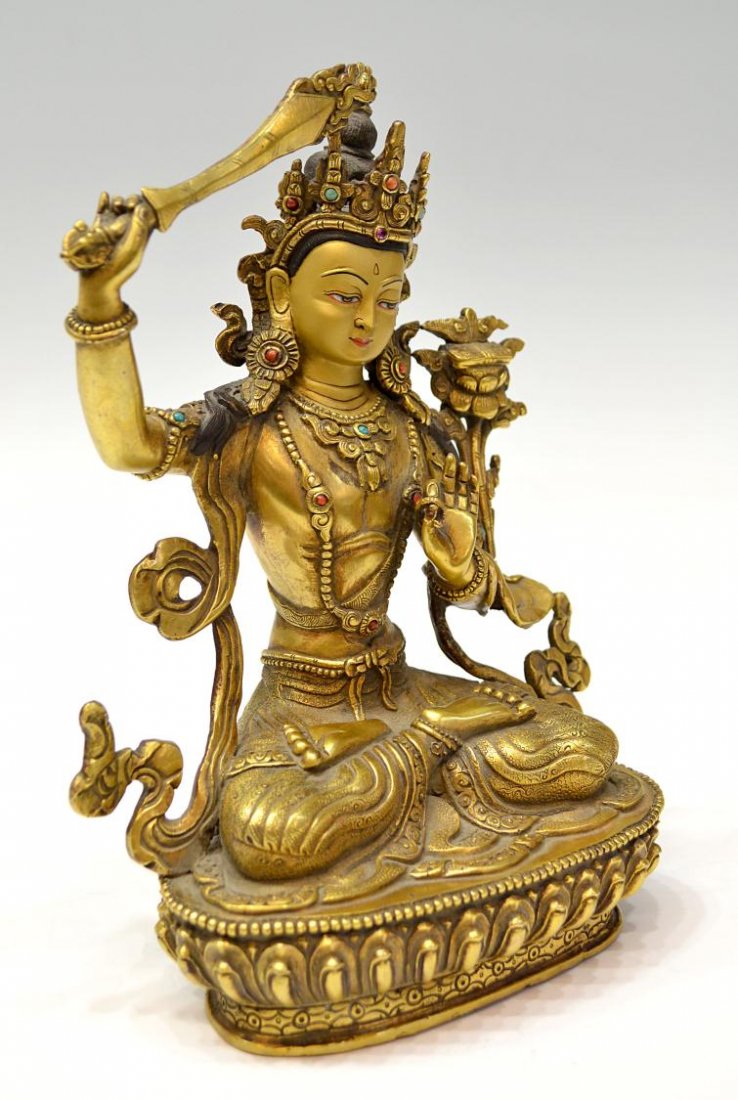 TIBETAN GILT BRONZE BUDDHIST FIGURE, MANJUSRI: Finely cast vintage parcel gilt bronze consecrated sculpture, Nepal, 20th c., Manjusri or Ma±jusrikumarabhuta, a Tibetan Buddhist deity, sitting in the dhyanasana position, polychrome accents, turquo