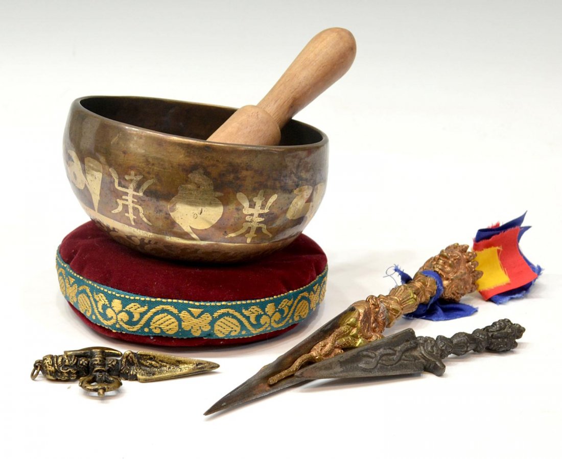 (4) TIBETAN BUDDHIST PHURBAS & GONG: (lot of 4) Tibetan Buddhist ritual phurbas, a three bladed ceremonial dagger and singing bowl: (1) sculptured brass with three faced Vajrakilaya deity at hilt, multi-color cloth tied to hilt, overall: