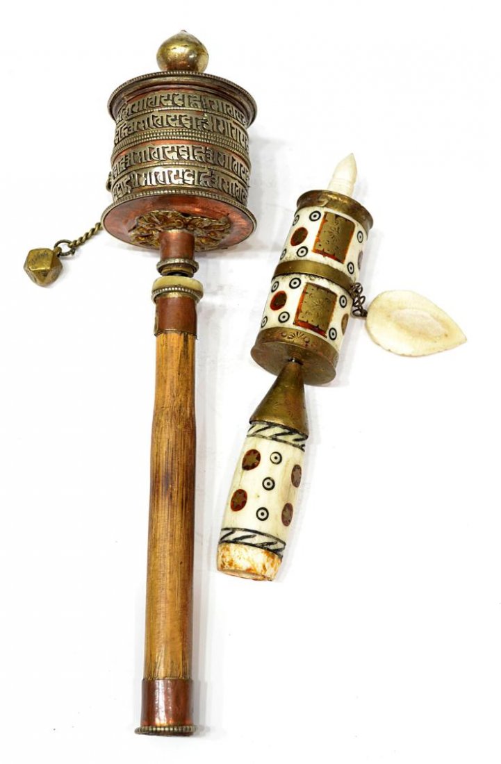 (2) TIBETAN BUDDHIST PRAYER WHEELS: (lot of 2) Buddhist prayer wheels, Nepal / Tibet: (1) carved bone and brass with auspicious symbols, 7.5"l, 1.3/8"d; (1) copper with silver Tibetan script around the cylindrical wheel, wood handle, 1.