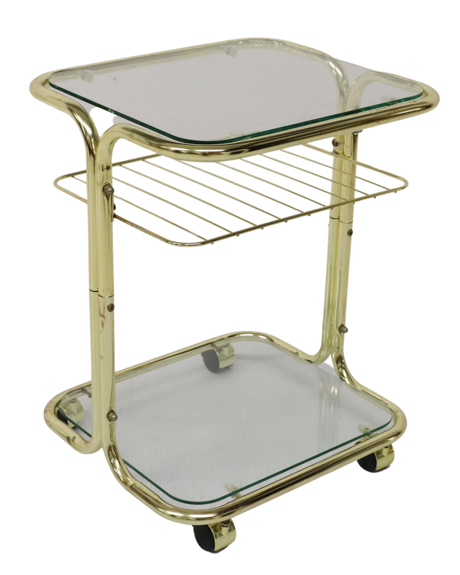 ITALIAN MODERN GILT TUBULAR STEEL TROLLEY/ CART: Diminutive Italian modern trolley or cart, c.1970s, gilt tubular steel frame, two colorless glass tiers, medial slatted tier, on casters, approx 21"h, 16.25"w, 14.5"d Start Price: $100.00