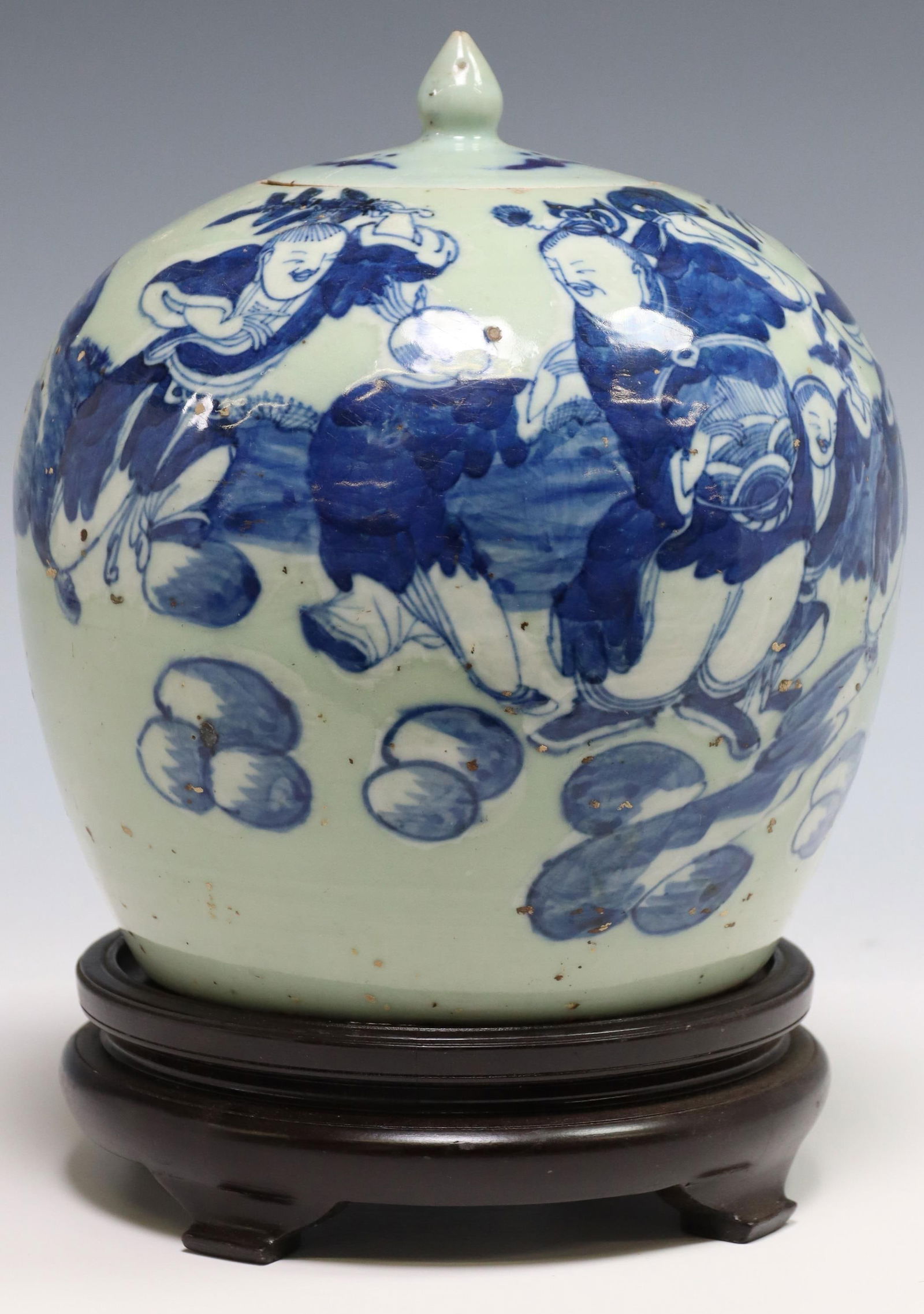 CHINESE BLUE & WHITE PORCELAIN GINGER JAR ON BASE: Chinese blue and white porcelain covered ginger jar, having tapered body, depicting scenes of dancing figures, rising on wood base, jar: approx 9.5"h, 7.75"diam, overall on stand: approx 11.5"h, 6lbs