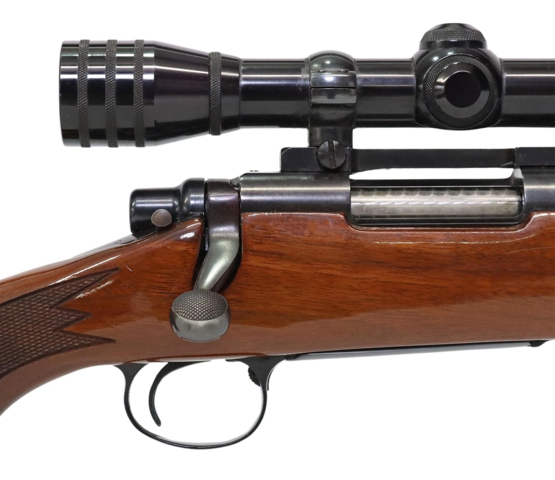 REMINGTON MODEL 700 BOLT ACTION .243 RIFLE & SCOPE: Remington Model 700 Rifle, bolt action, .243 Win caliber, fixed front sight lacking post, adjustable rear sight, mounted Redfield 4X scope, jeweled bolt, gloss finish checkered stock with cheekpiece,