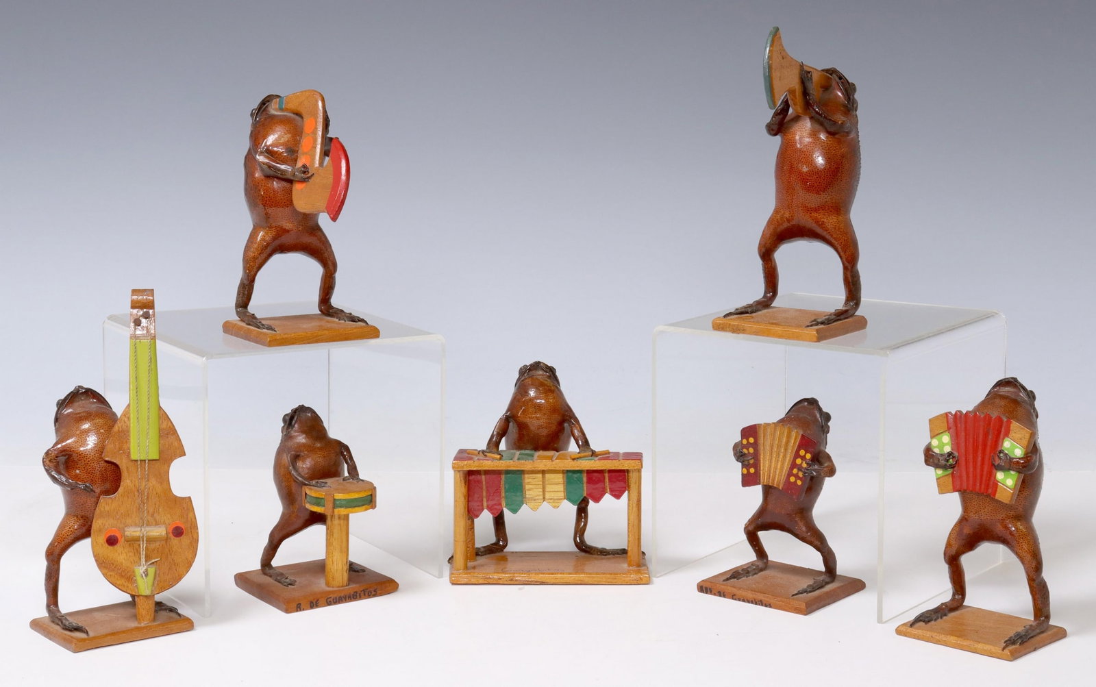 (7) TAXIDERMY FROG MUSICIANS, GUAYABITOS, MEXICO: (lot of 7) Taxidermy frogs, Rincon de Guayabitos, Mexico, 20th c., each modeled as a musician, on integral rectangular base, (three) signed Guayabitos at base, largest: approx 6"h, 2.75"w, 1.75"d,